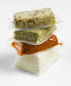 Various types of tofu in plastic packaging, stacked