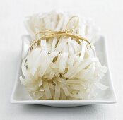 Broad rice noodles, tied together