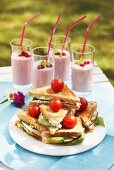 Triangular toast sandwiches with cocktail tomatoes & berry shakes