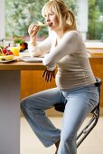 Pregnant woman having breakfast