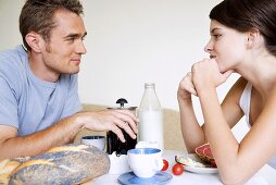 Young couple sitting at breakfast table