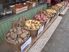 Different varieties of potatoes in baskets at a market