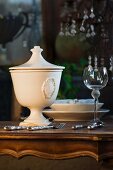 Place-setting, soup tureen and wine glass