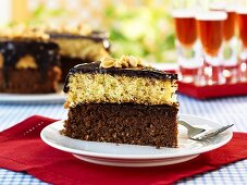 Piece of black & tan cake in front of cake with piece removed