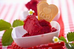 Strawberry sorbet with heart-shaped wafer