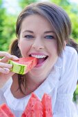 Young woman eating watermelon