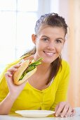 Girl eating vegetable sandwich