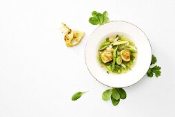 Scallops with asparagus and lime in clear broth (overhead view)