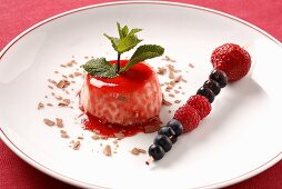 Panna cotta with strawberry sauce and berry skewer