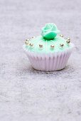 Cupcake (turquoise with silver dragees and marzipan rose)