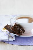 Chocolate brownies beside cup of coffee