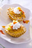 Cheese tarts topped with cream and candied fruit