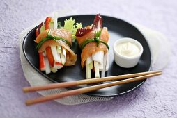Smoked salmon rolls filled with vegetables and surimi