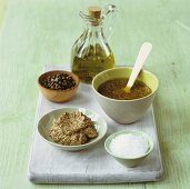 Mustard dressing with ingredients (Dijon mustard, salt, pepper, oil)