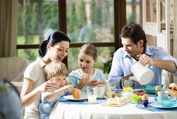 Family of four at breakfast table