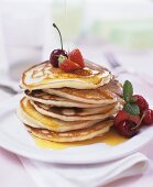 Pancakes with maple syrup, berries and cherries