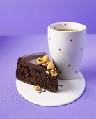 Chocolate cake with hazelnuts, beaker of tea
