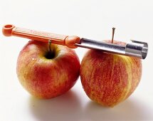 Two apples with apple corer
