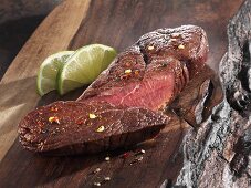 Roasted ostrich fillet on a wooden board