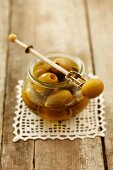 Marinated green olives on an olive fork