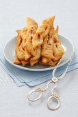 Polish Faworki (deep-fried pastry) with herring