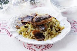 Fried herring on a bed of white cabbage for Christmas dinner