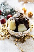 Silesian Christmas dessert made of cooked potatoes with a dried fruit sauce and cinnamon