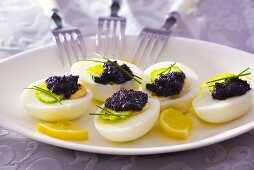 Boiled eggs with black caviar