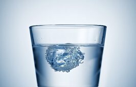 Ice cube in a glass of water