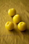 Four yellow plums