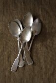 Five antique silver teaspoons (overhead view)