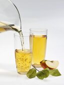 Pouring apple juice into glass