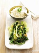 Sautéed pak choi with garlic and a bowl of rice