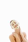 Young woman with herbal facial mask