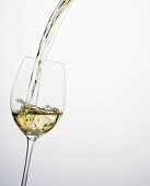 Pouring white wine into a glass