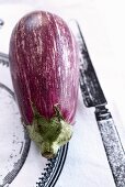 Aubergine on printed tablecloth