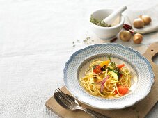 Spaghetti with fried vegetables and thyme