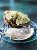 Oyster with a bread roll and herb butter