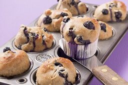 Taking blueberry muffins out of muffin tin
