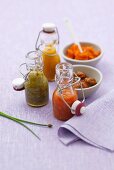 Three chilli sauces in bottles, lobster paste & marinated shellfish