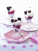 Three glasses of parfait with cherries and brownies