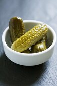 Three gherkins in a small bowl