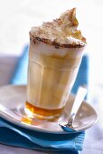 A glass of caffe latte caramel with whipped cream