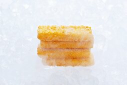 Frozen fish fingers on ice