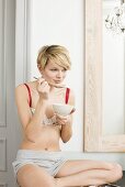 Young woman eating muesli