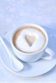 Cappuccino with heart-shaped biscuit