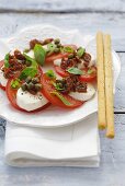 Mozzarella & tomatoes with dried tomatoes, capers, grissini