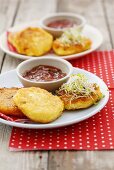 Small cheese pancakes with sprouts and tomato dip