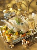 Guinea fowl with herb stuffing on a bed of vegetables