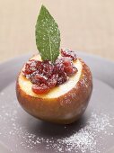 Pear with cranberries, icing sugar and bay leaf